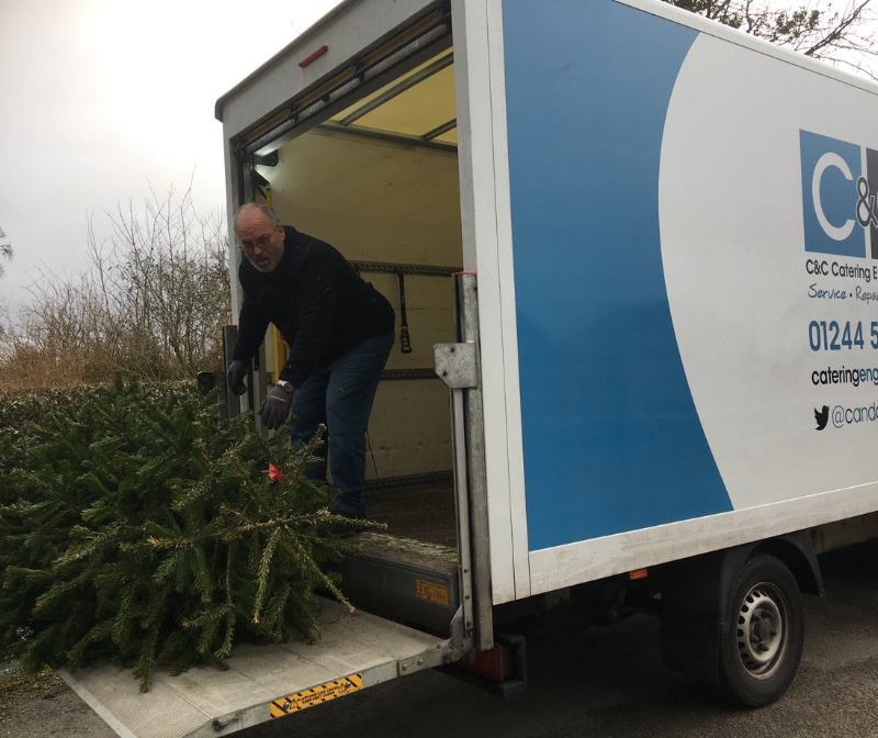 C&C Catering Engineers loading Christmas tree in to one of their lorries for a local charity, Christmas 2019